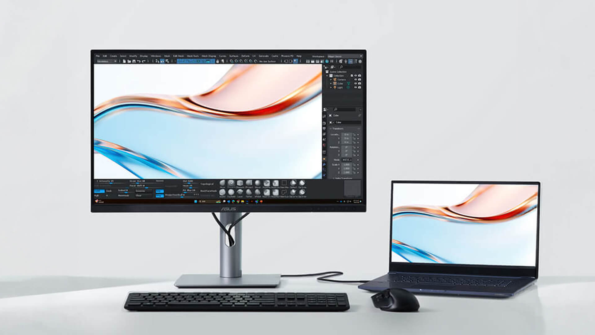 ASUS monitor connected to a laptop for creative work.