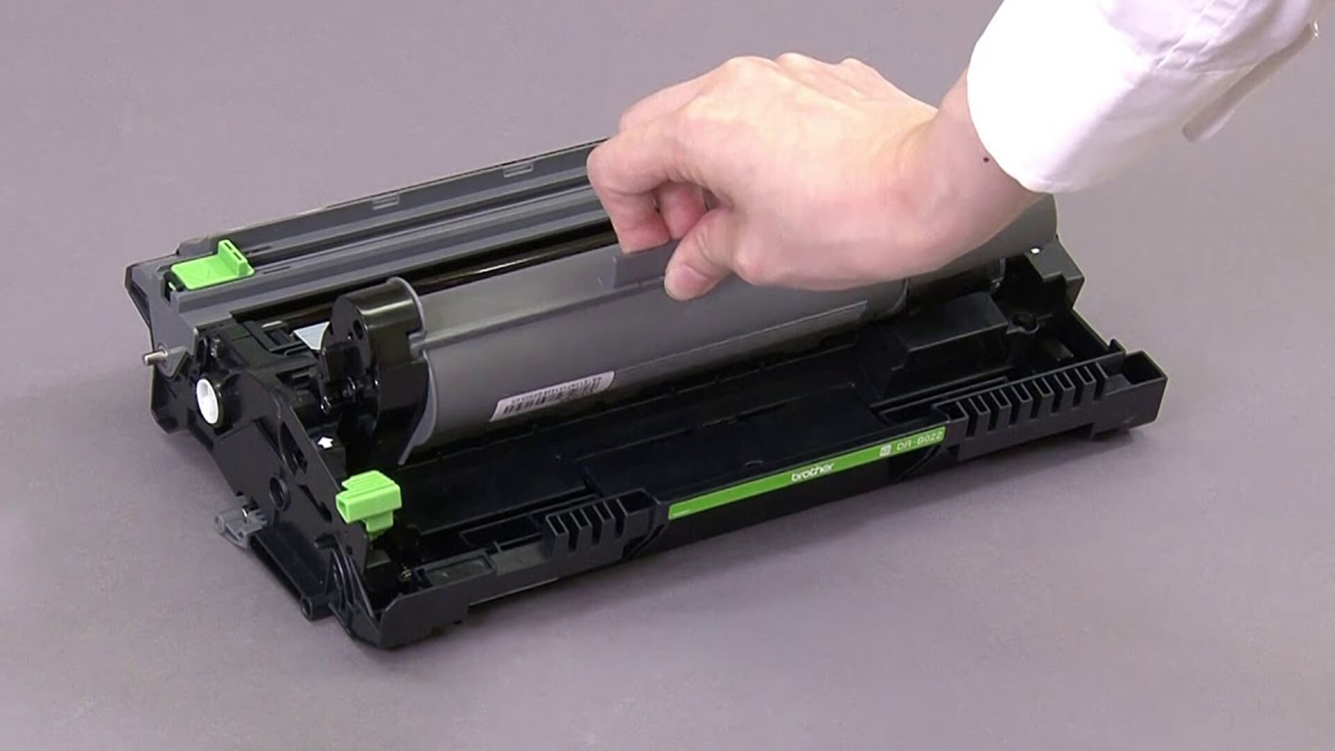 Removing the Brother toner cartridge from the drum unit assembly.