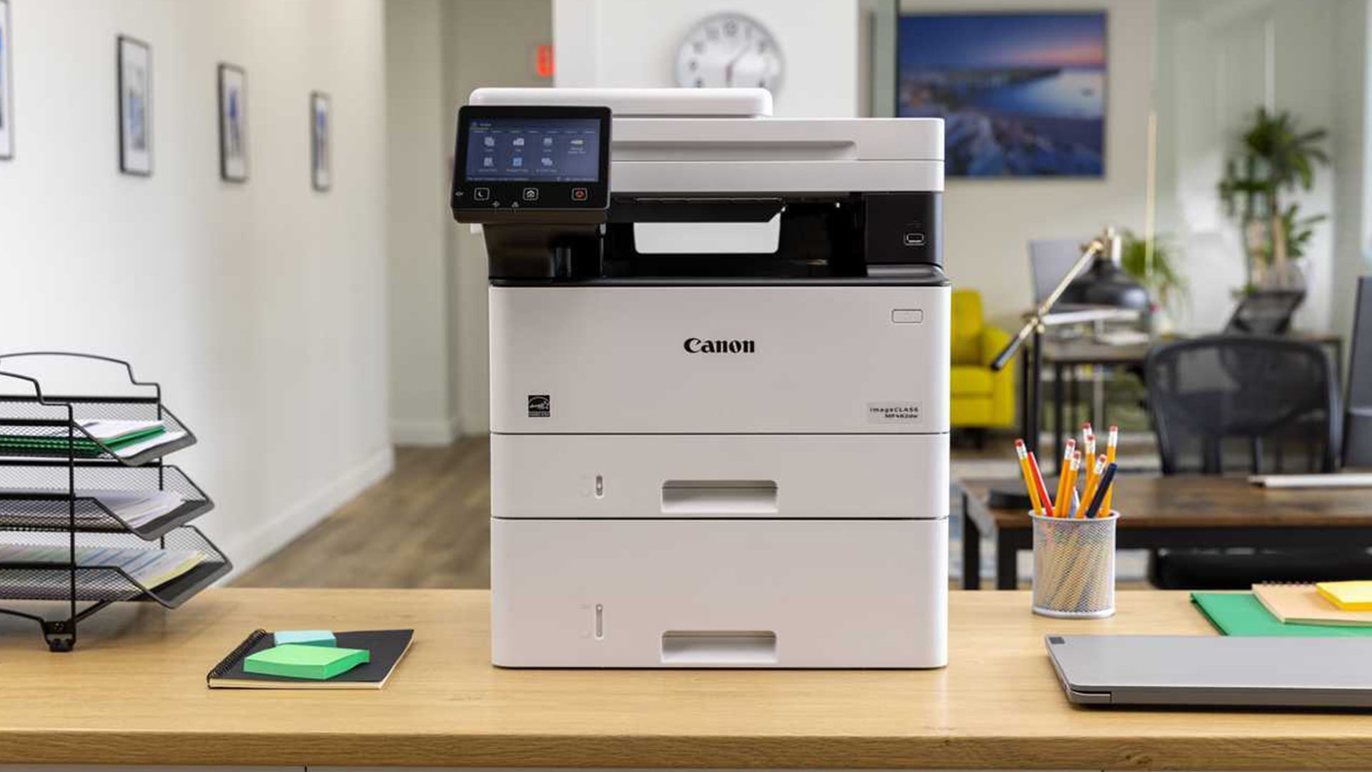 Canon multifunction color laser printer on a desk.