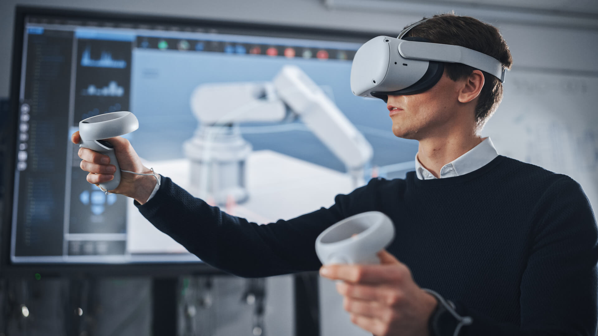 A student using a VR headset and controllers for 3D modeling.