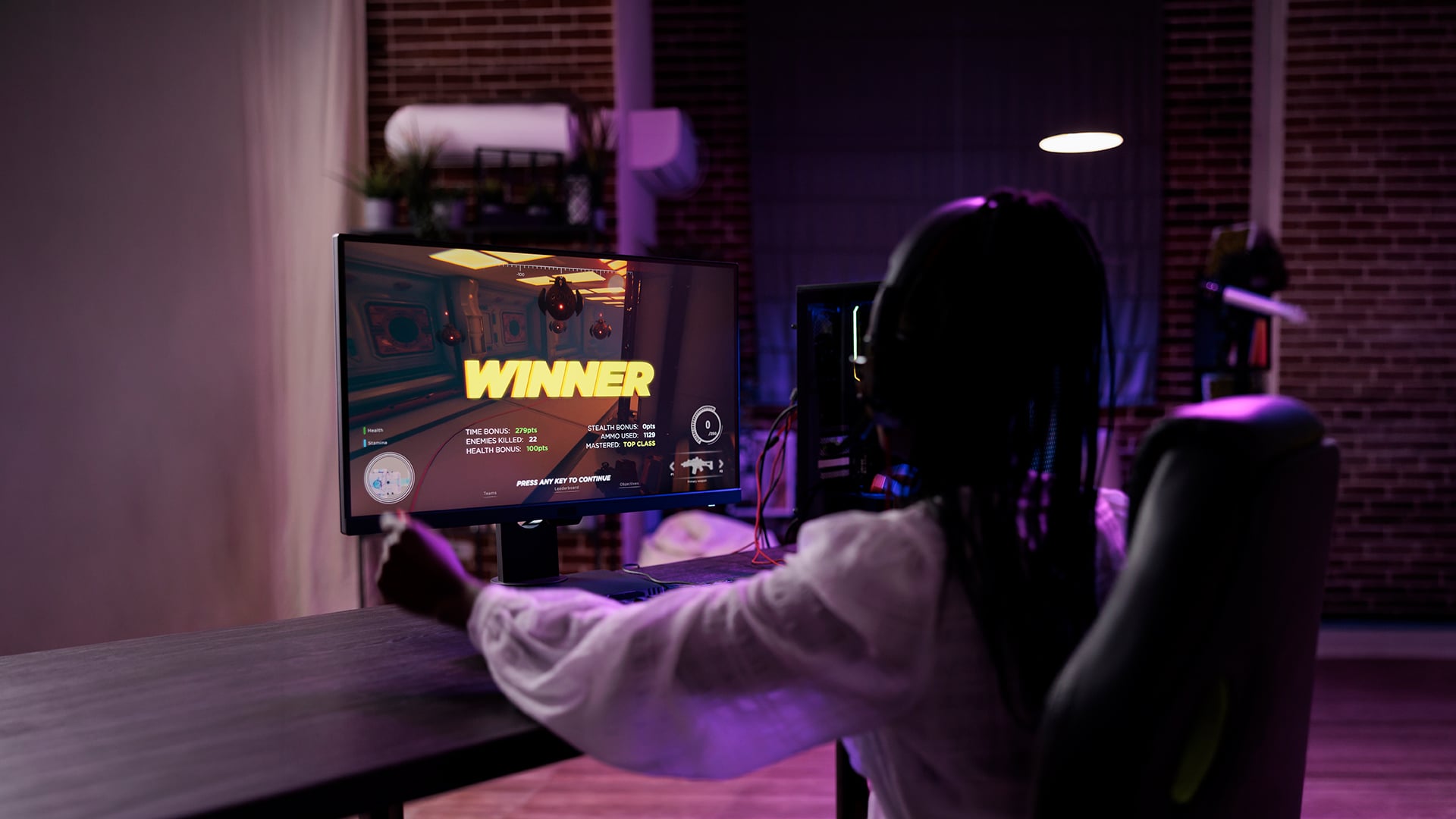 A gamer playing an online match on a powerful gaming PC.