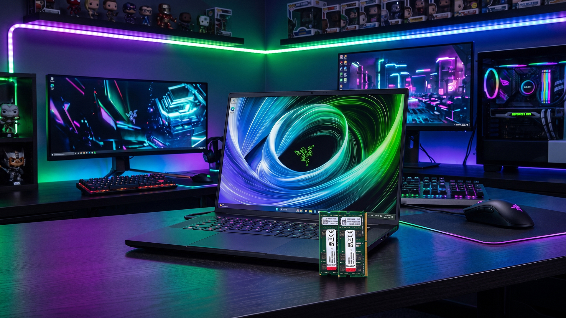 Gaming laptop on a desk with RAM memory sticks in the foreground.