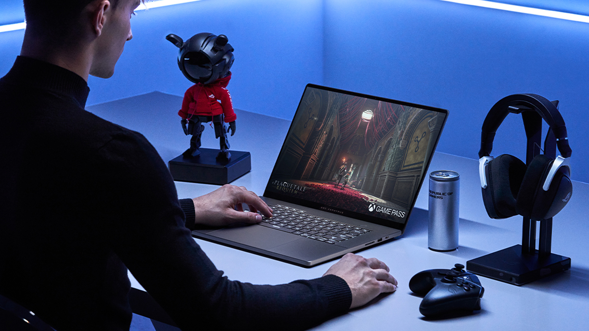 A gamer playing an immersive adventure game on a laptop.