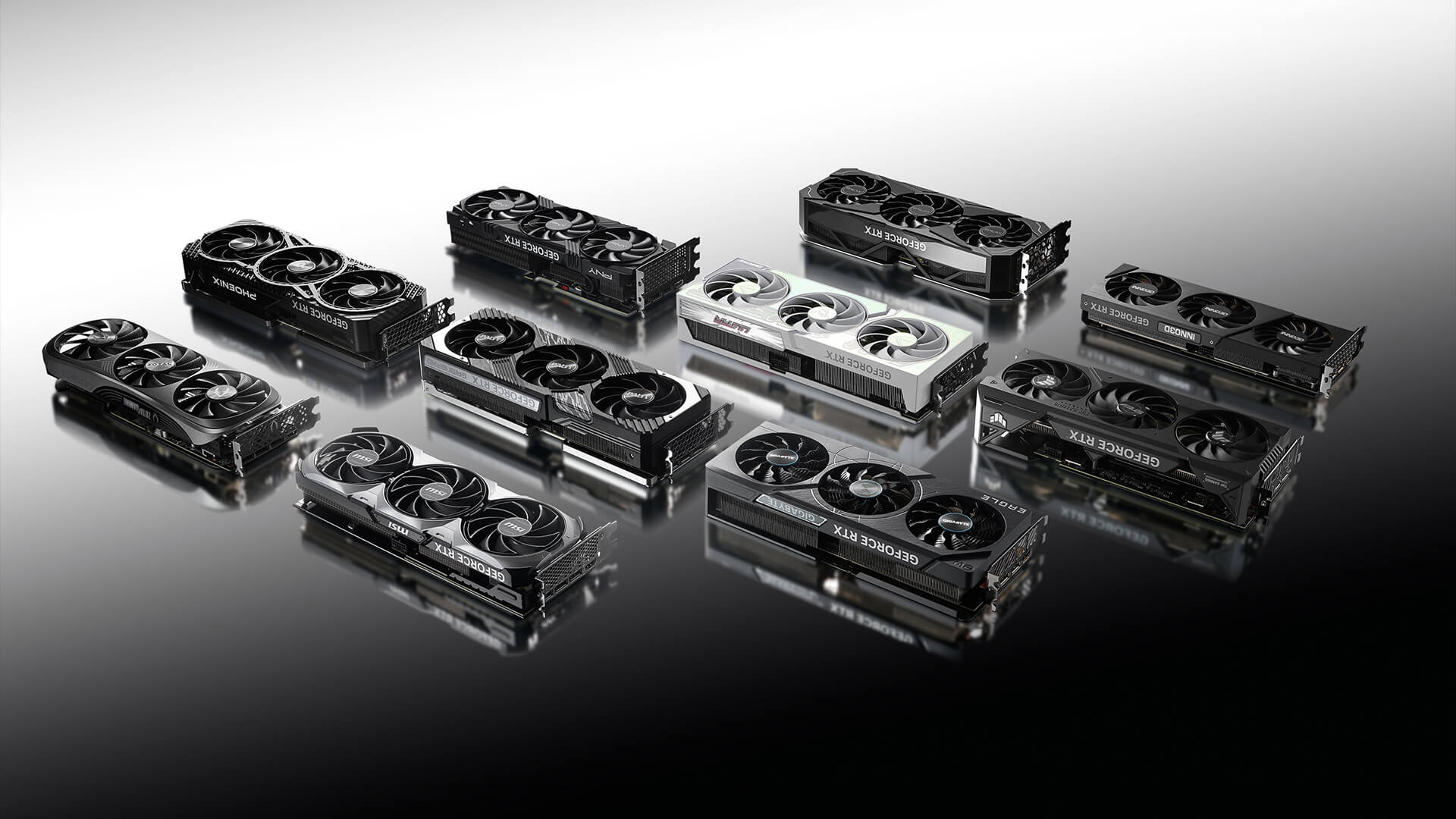 Several graphics cards lined up on a reflective surface.