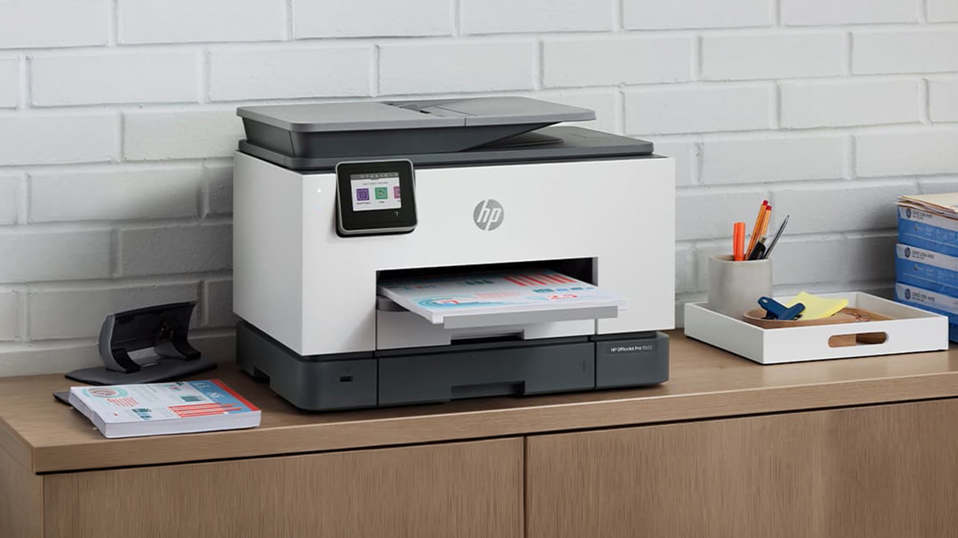 HP OfficeJet Pro printer sitting on a desk.