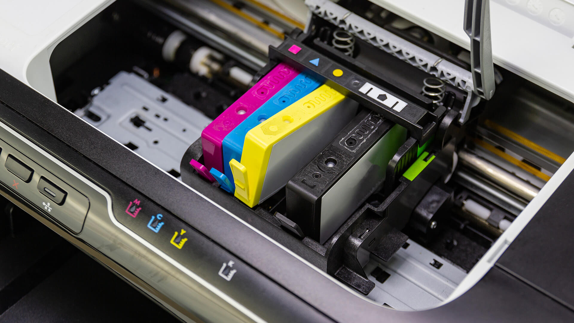 Manually refilling magenta ink in printer.