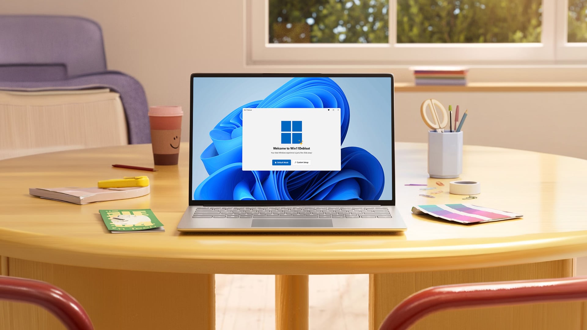 Laptop open on a table displaying the Win11Debloat app interface on screen.