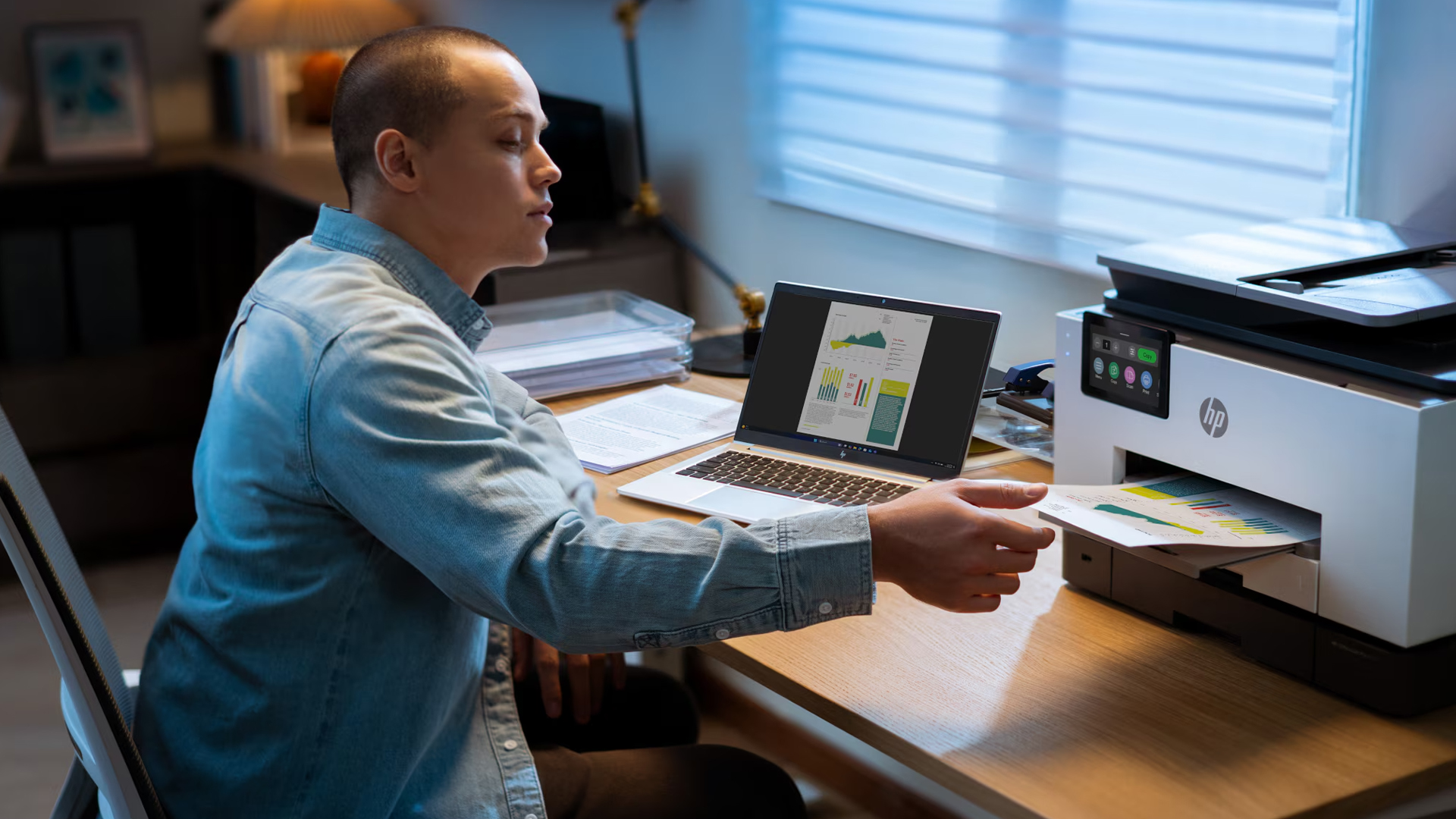 A man reaching to pick up a printed report from an HP printer.