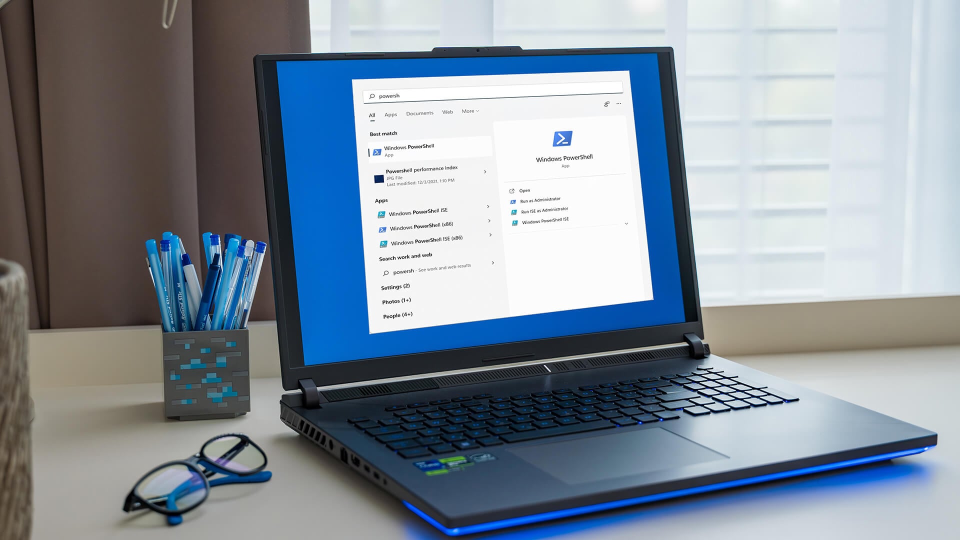 Man typing on a laptop showing the Windows Run dialog box on a Windows 11 desktop.