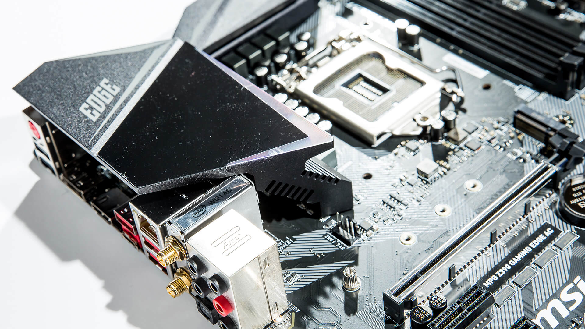 Close-up of an MSI gaming motherboard showing rear I/O ports and heatsink design.