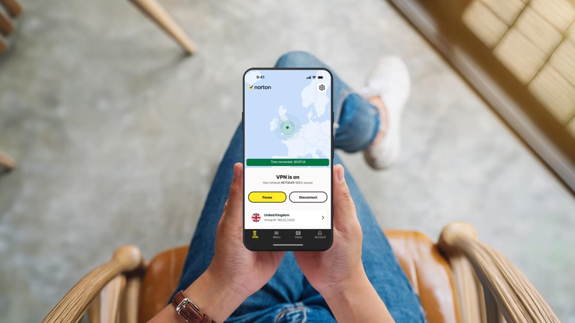 A person holding a smartphone with Norton VPN turned on.