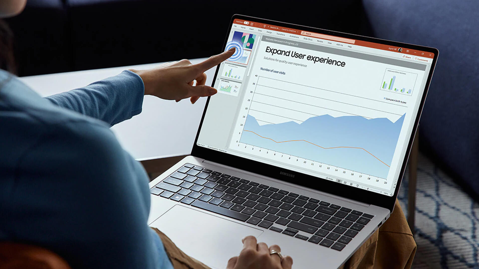 Person using the touchscreen on a Samsung Galaxy Book laptop.