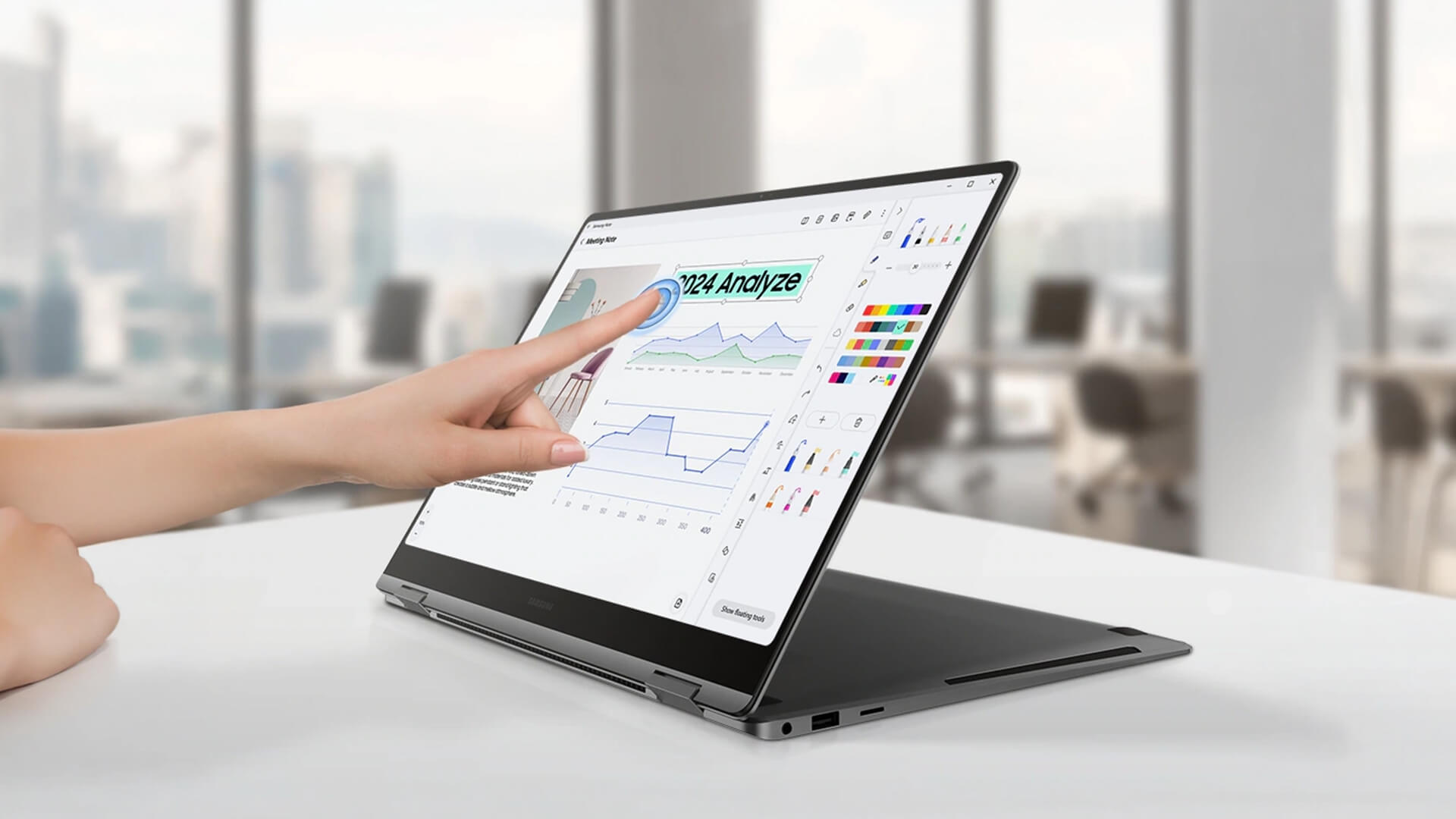 A person using the touchscreen on a Samsung 2-in-1 laptop.