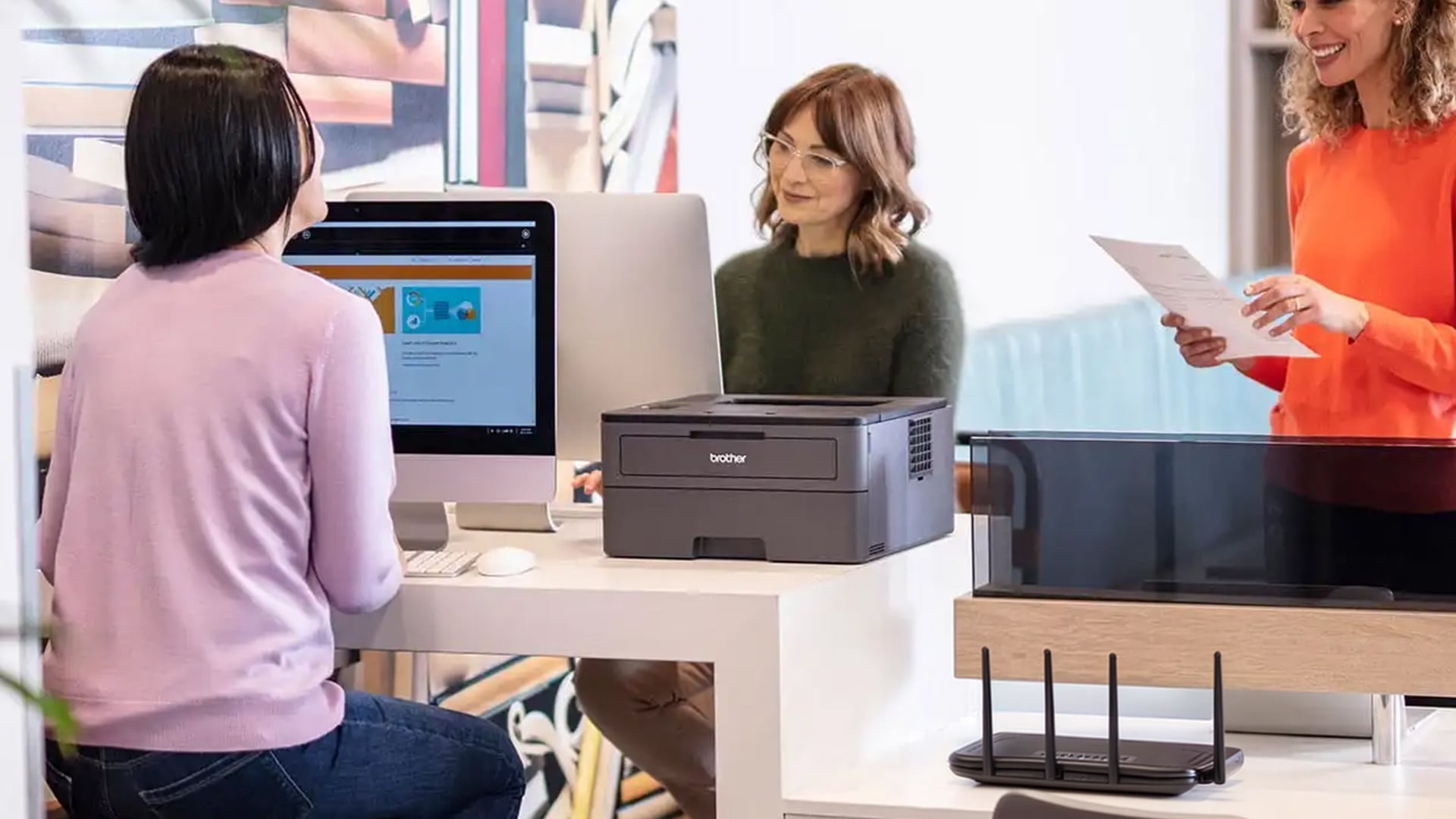 Team sharing a wireless Brother printer at work.