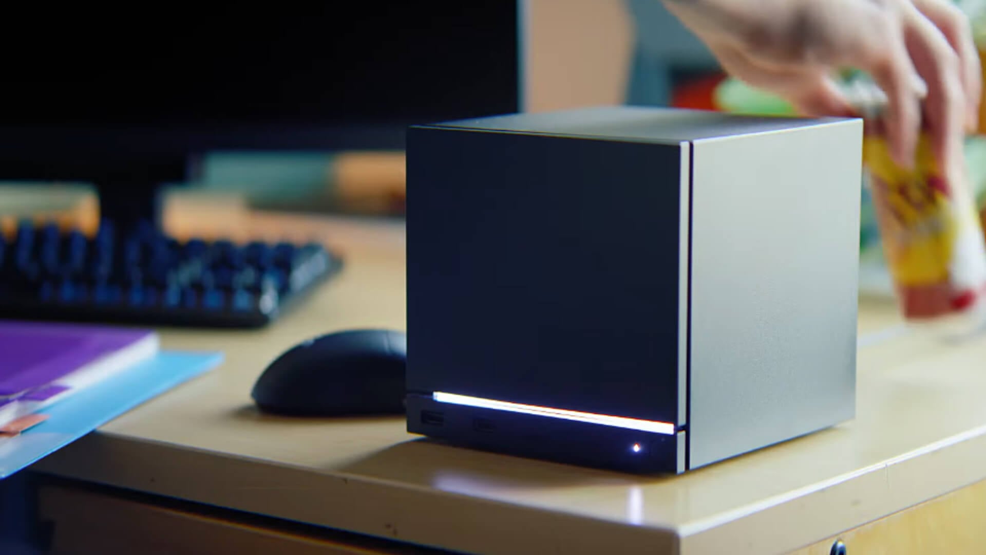 A close-up view of the compact Steam Machine cube on a desk.