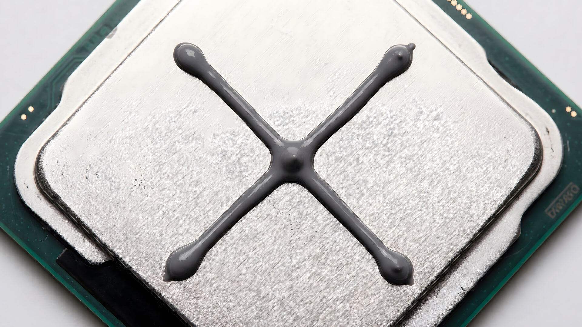 Thermal paste applied to a CPU using the X-pattern.
