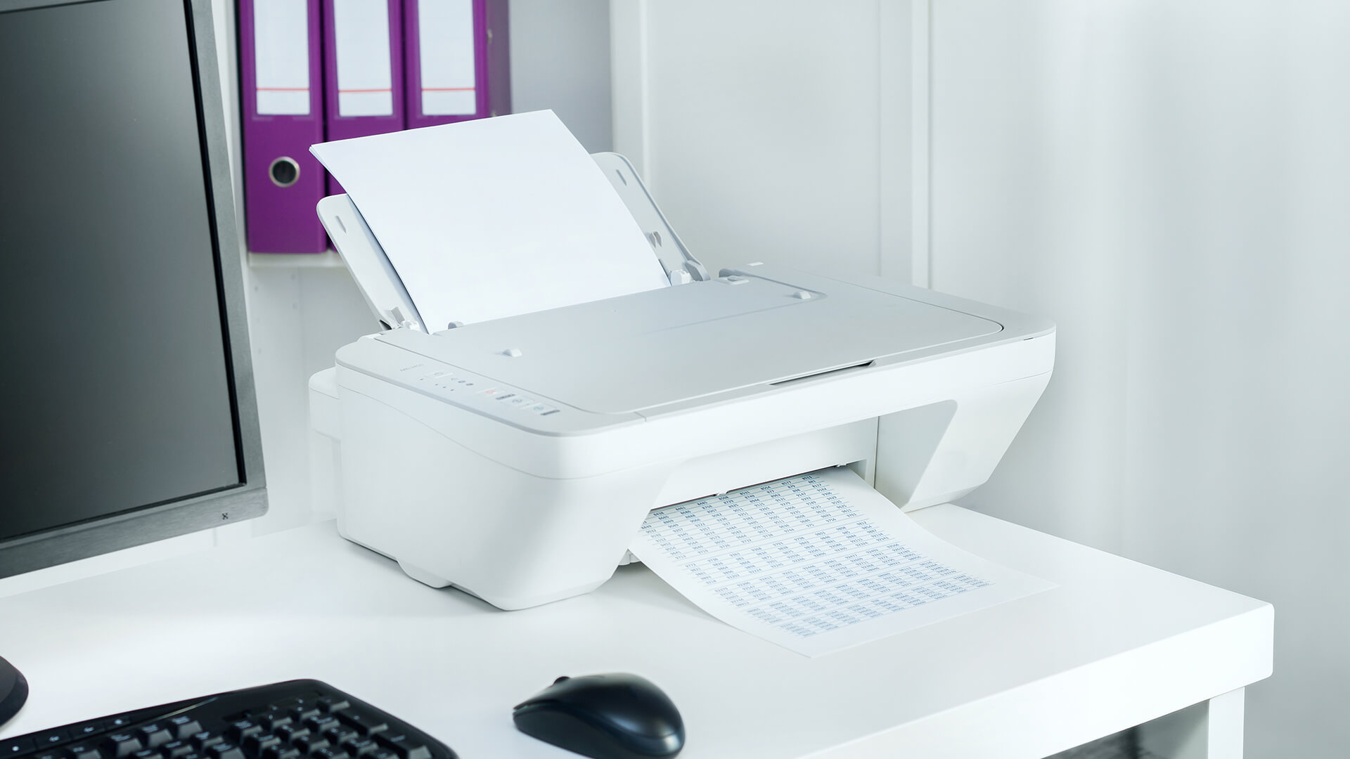 White printer on desk connected for simple USB printing.