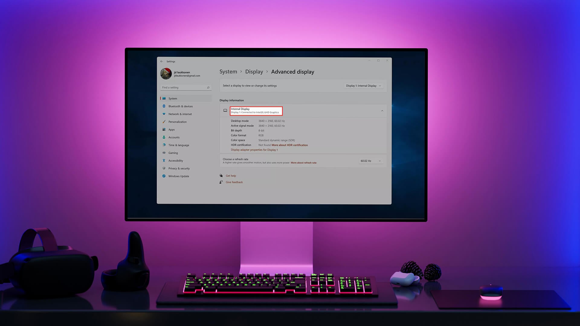 Monitor showing Windows 11 Advanced display settings in a purple-lit setup.