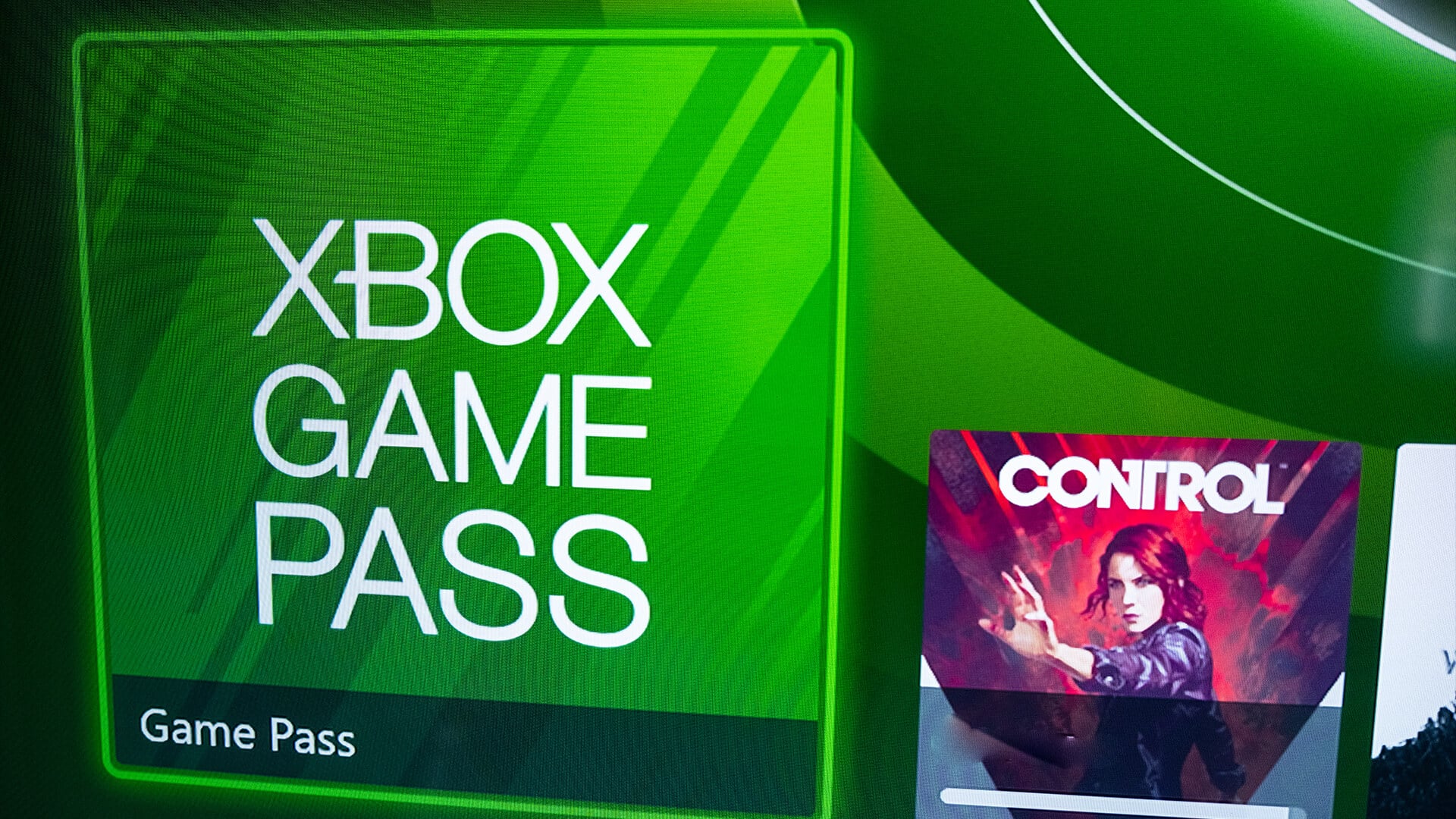 Close-up view of the digital Xbox Game Pass branding on a screen.